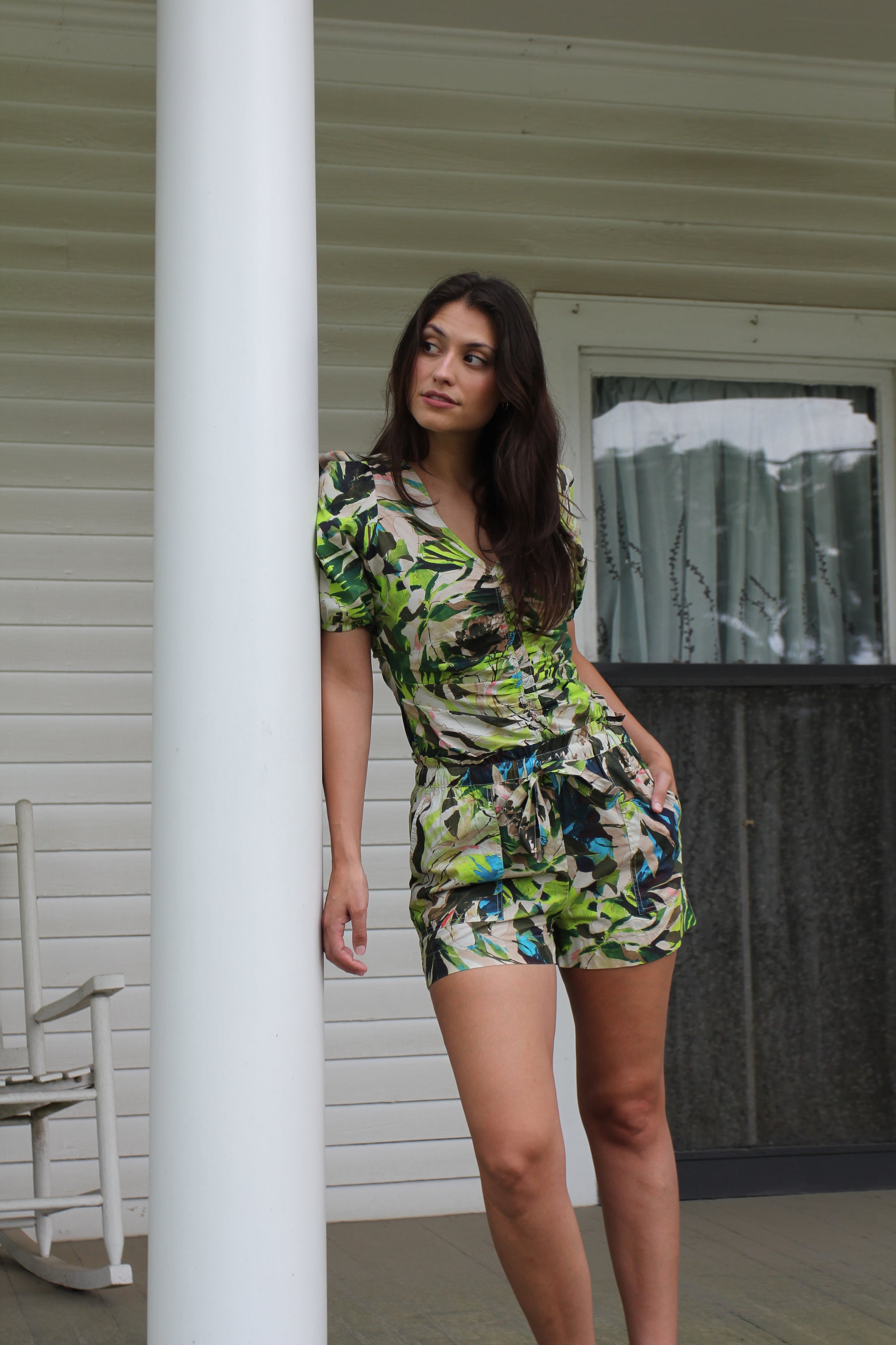 Model wearing the Love the Label Paloma Set featuring a tropical green print puff-sleeve top with front ruching and matching tie-waist shorts.