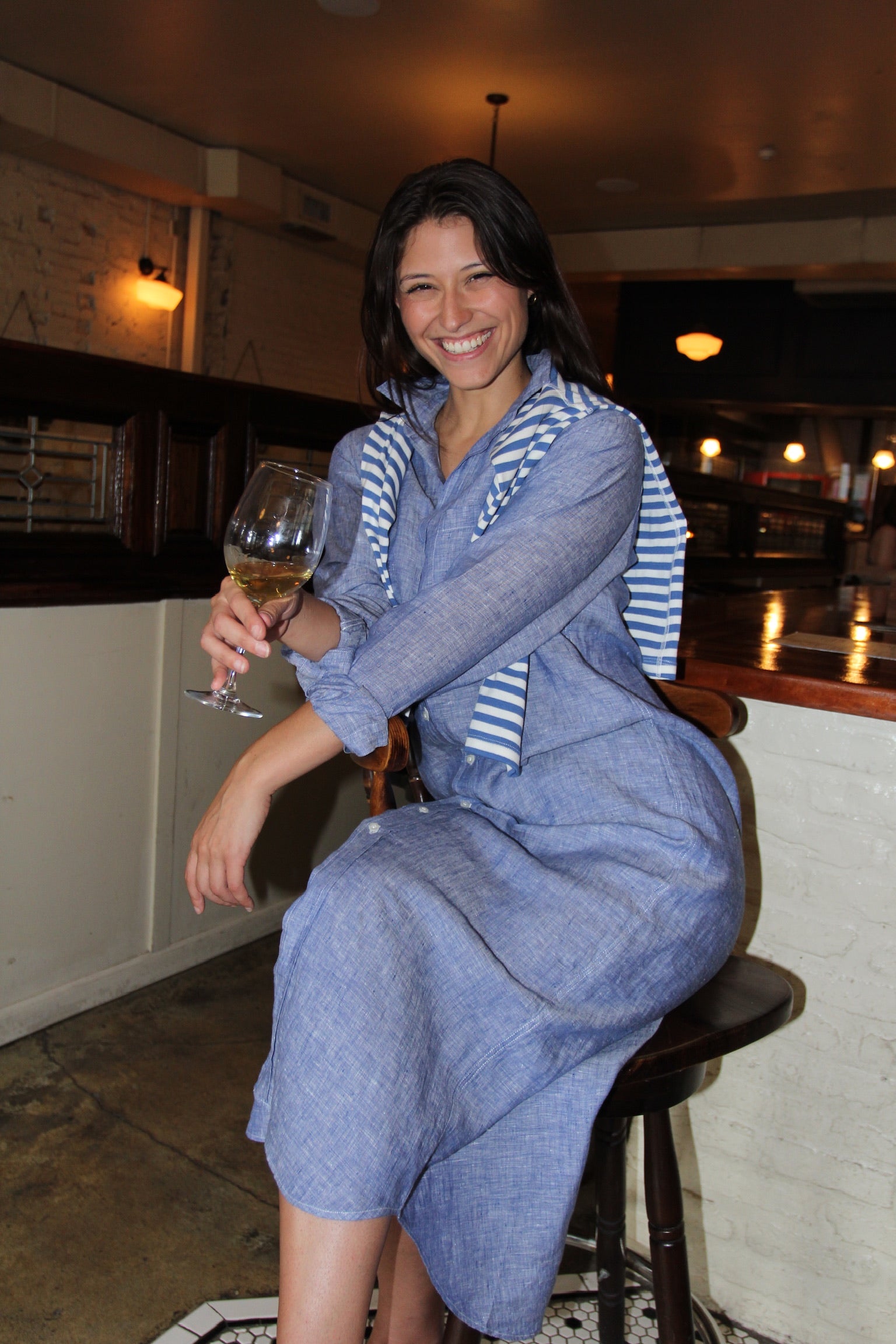 Model wearing Frank & Eileen Rory blue linen shirt dress styled as a coastal luxury vacation outfit